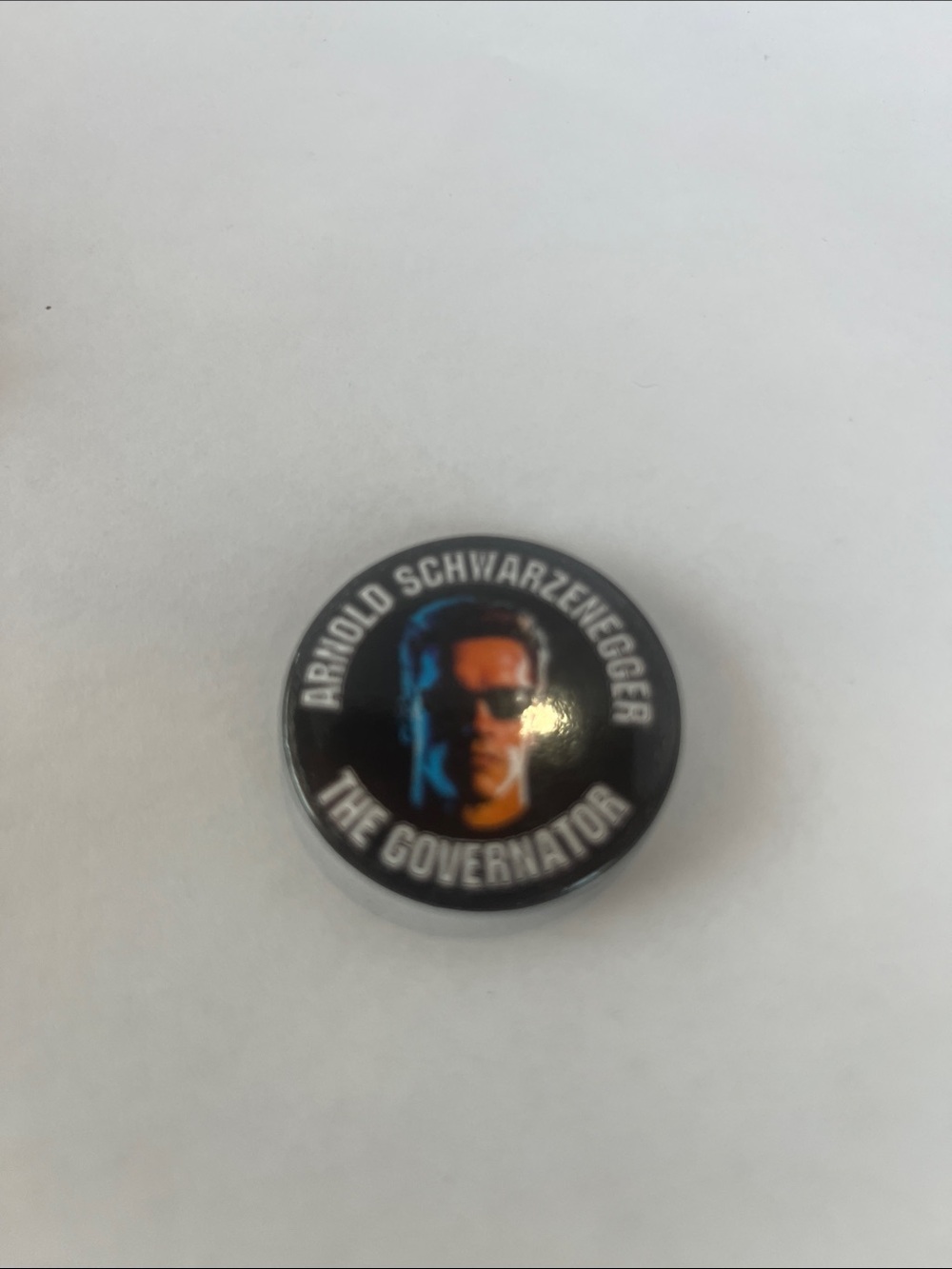Arnold Schwarzenegger 'The Governator' Pin - Black with Blue & Orange